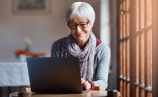 Photograph of woman looking at computer screen assisting with the maintenance of the church directory